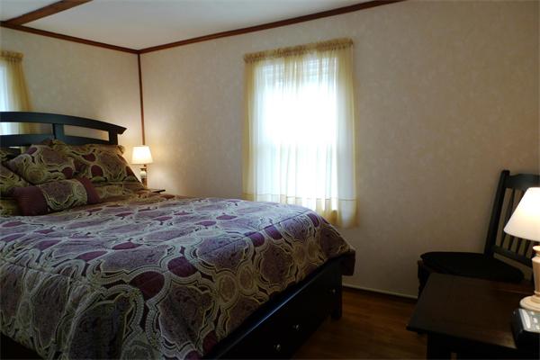 323 Appleton Street Arlington, MA 02476 - Photo 7 of 9 a bedroom with a bed a window and chair
