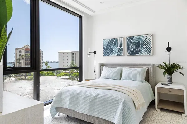a bedroom with a large window and a bed