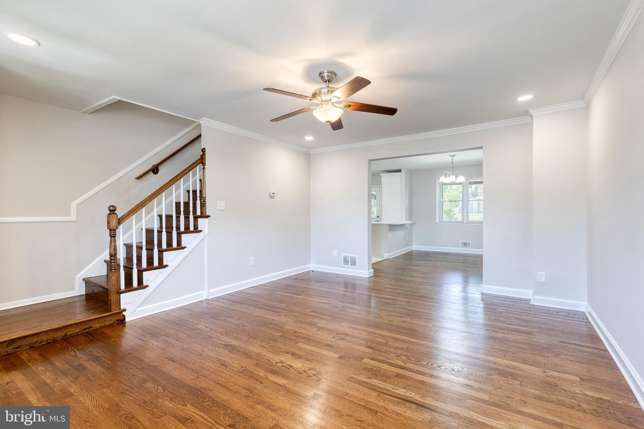 5649 Utrecht Road Baltimore, MD 21206 - Photo 6 of 42 a view of an empty room with wooden floor and a ceiling fan