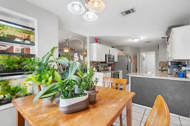 a kitchen with a table and chairs in it