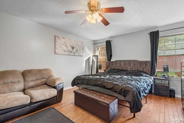 a bedroom with a bed couch and window