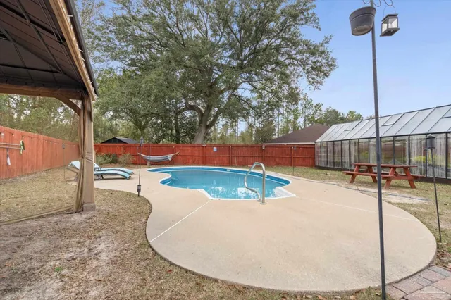 a view of a swimming pool with a patio