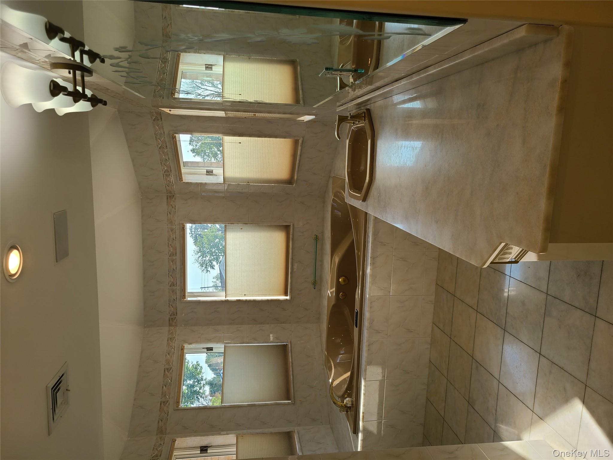 14 Potters Lane New Rochelle, NY 10805 - Photo 11 of 14 a bathroom with a granite countertop sink a mirror and a bathtub