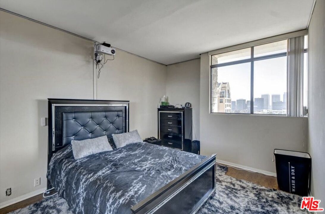 10535 Wilshire Boulevard, Unit 1701 Los Angeles, CA 90024 - Photo 11 of 18 a bedroom with a large bed and a window