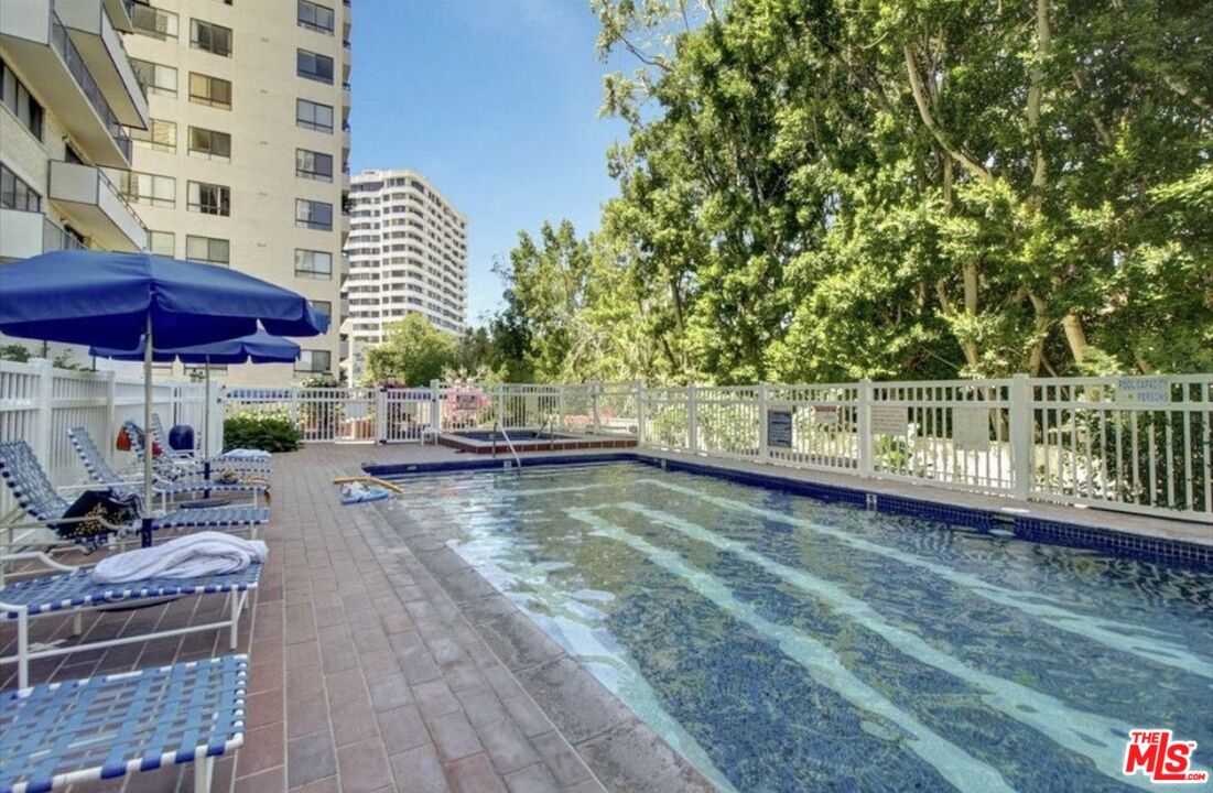 10535 Wilshire Boulevard, Unit 1701 Los Angeles, CA 90024 - Photo 15 of 18 a view of a swimming pool with chairs in patio