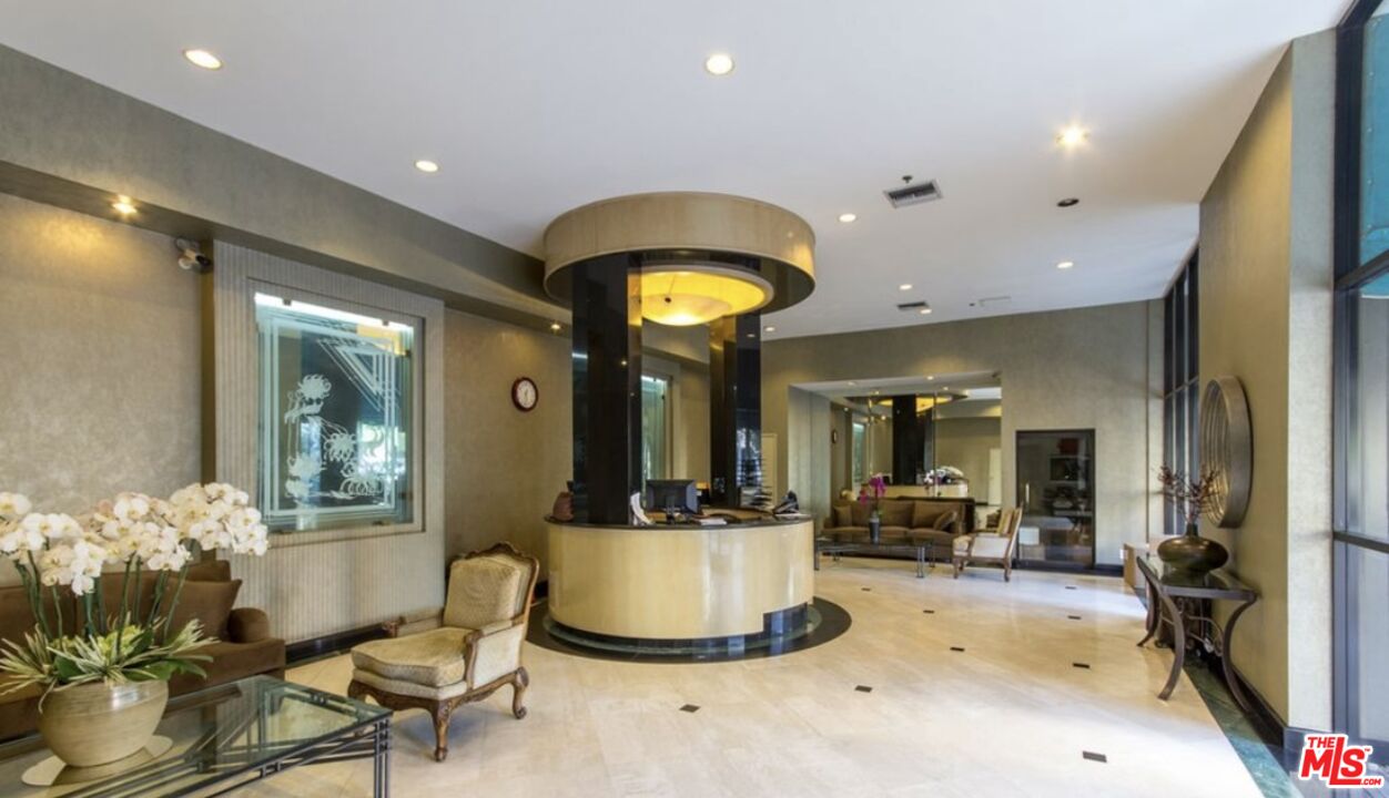 10535 Wilshire Boulevard, Unit 1701 Los Angeles, CA 90024 - Photo 2 of 18 a living room with furniture and a large mirror