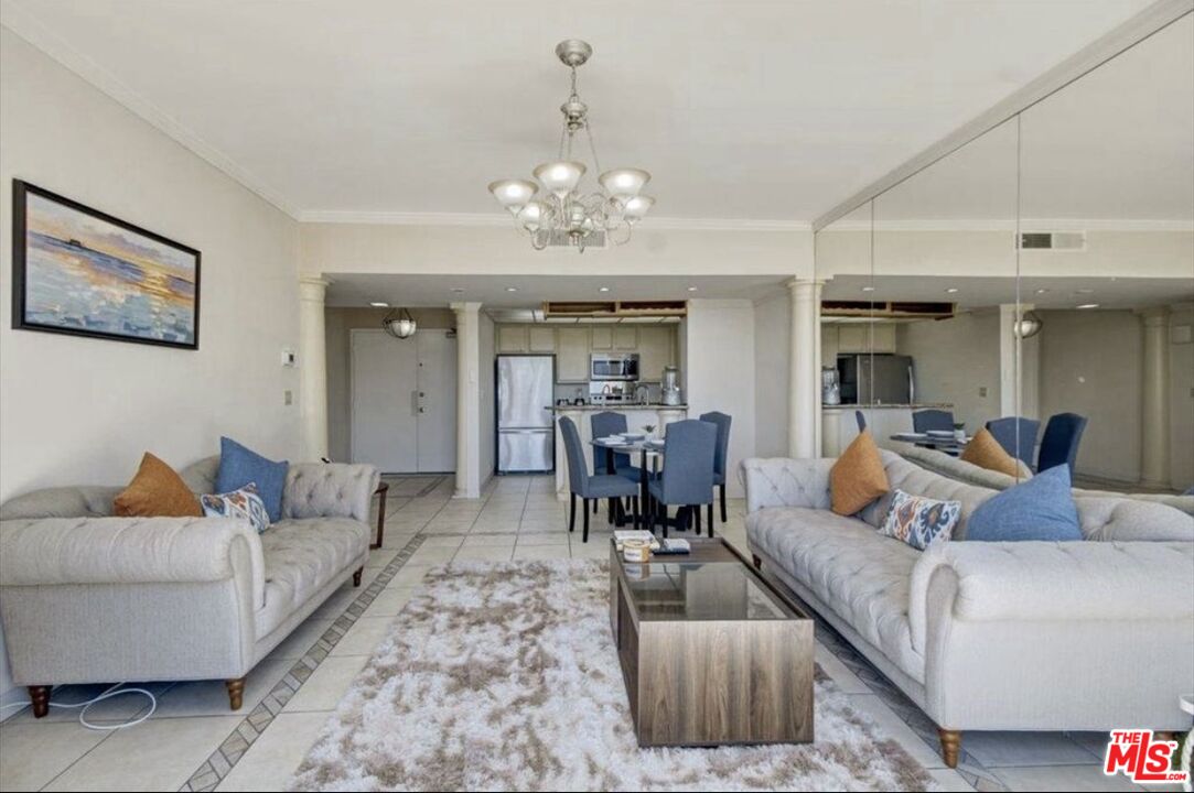 10535 Wilshire Boulevard, Unit 1701 Los Angeles, CA 90024 - Photo 5 of 18 a living room with furniture and a chandelier