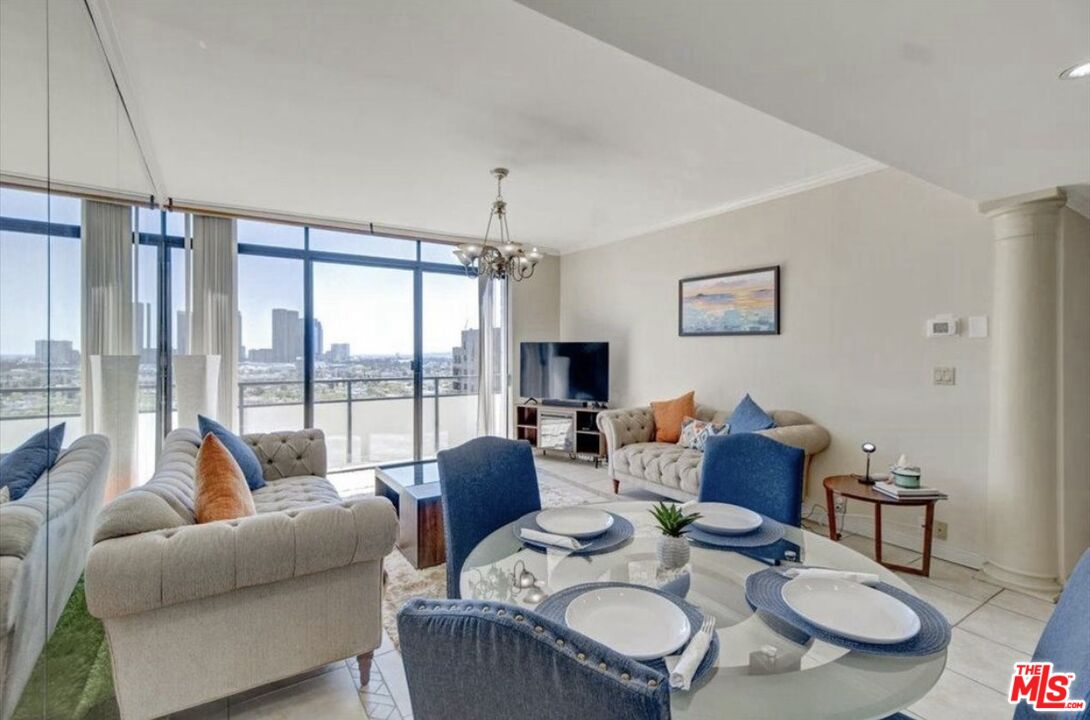 10535 Wilshire Boulevard, Unit 1701 Los Angeles, CA 90024 - Photo 6 of 18 a living room with furniture and a floor to ceiling window