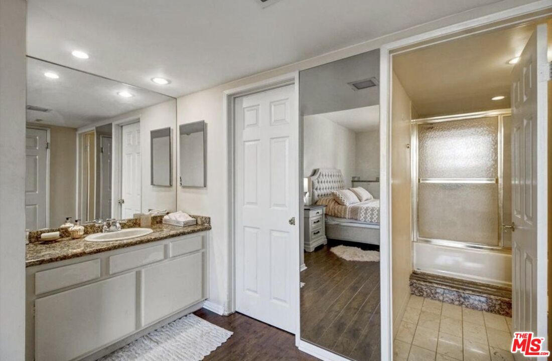10535 Wilshire Boulevard, Unit 1701 Los Angeles, CA 90024 - Photo 9 of 18 a en suite bathroom with a shower sink and mirror
