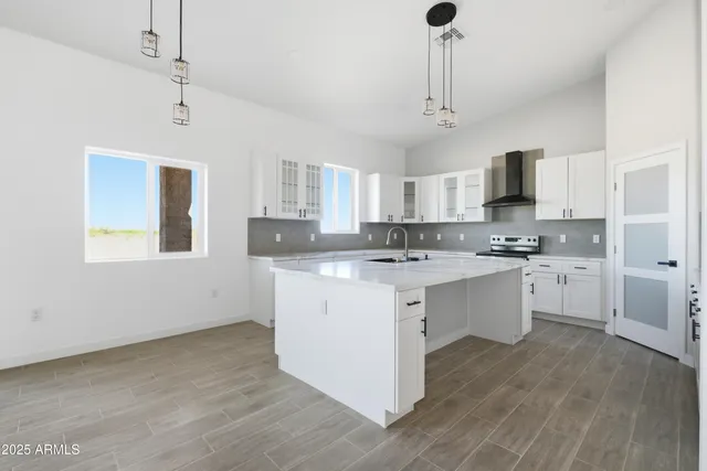 a kitchen with cabinets appliances a sink and a counter top space
