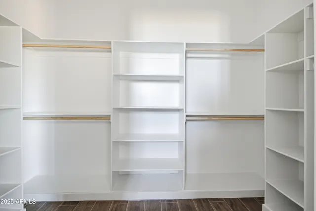a bathroom with a shower a mirror and a sink