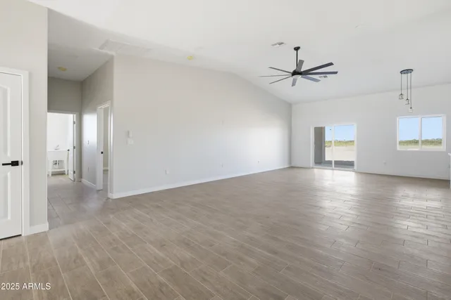 a view of a kitchen with wooden floor and a ceiling fan