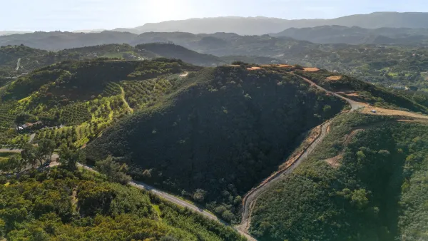 a view of a town with mountains in the background