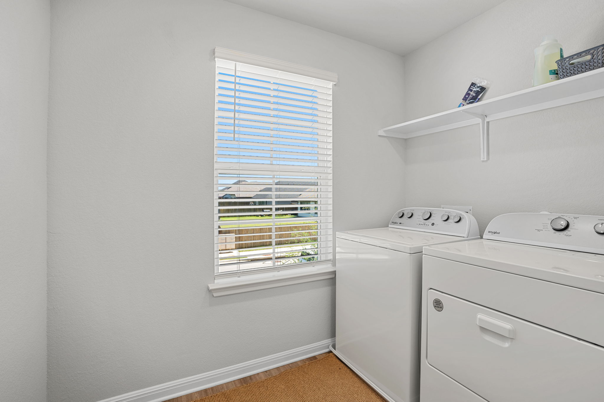 148 Hidalgo Lane Elgin, TX 78621 - Photo 31 of 38 A dedicated laundry room with convenient shelving and natural light.