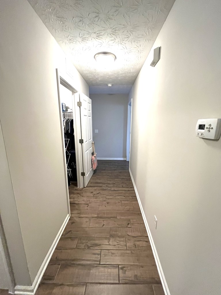 6067 Townes Way Columbus, GA 31909 - Photo 15 of 35 a view of a hallway with wooden floor and staircase