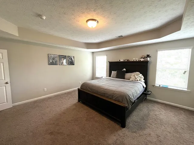 a bed sitting in a room next to a window