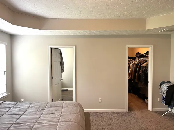 a bedroom with a bed and a walk in closet