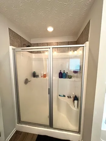 a bathroom with a glass shower door