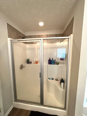 a bathroom with a glass shower door