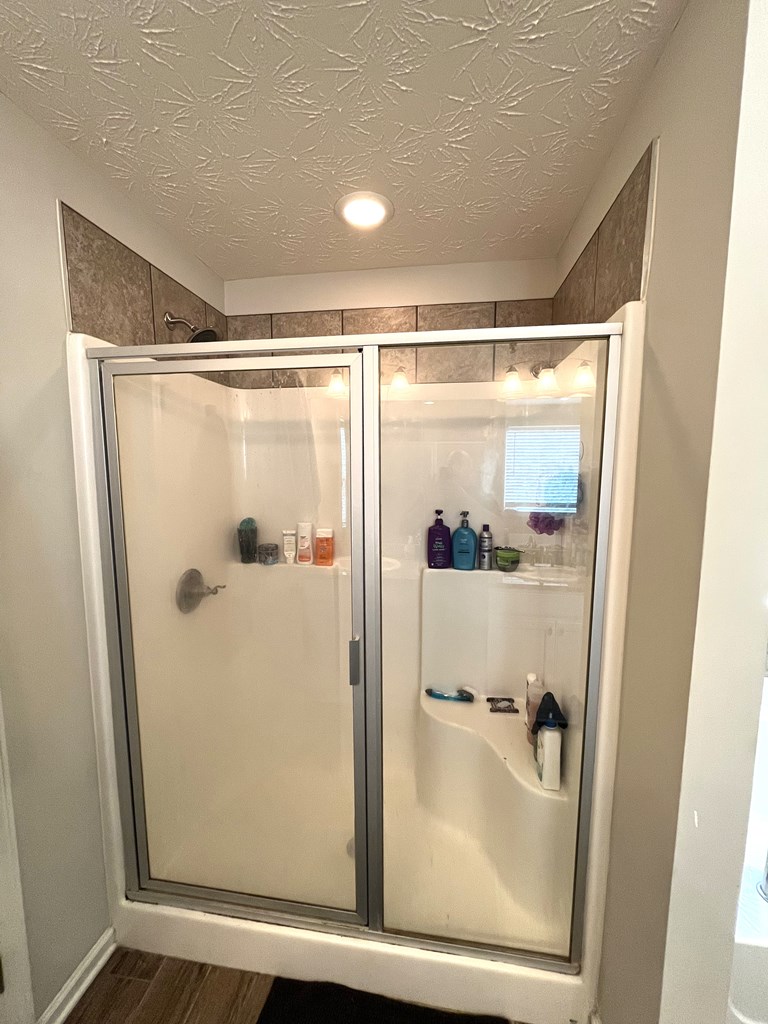 6067 Townes Way Columbus, GA 31909 - Photo 23 of 35 a bathroom with a glass shower door