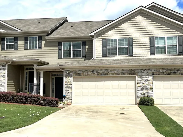 a front view of a house with a garden