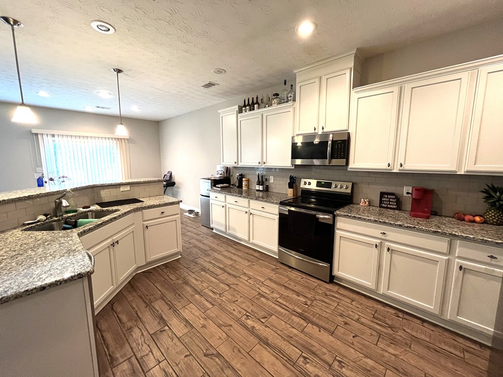 6067 Townes Way Columbus, GA 31909 - Photo 8 of 35 a kitchen with a sink stove top oven and cabinets
