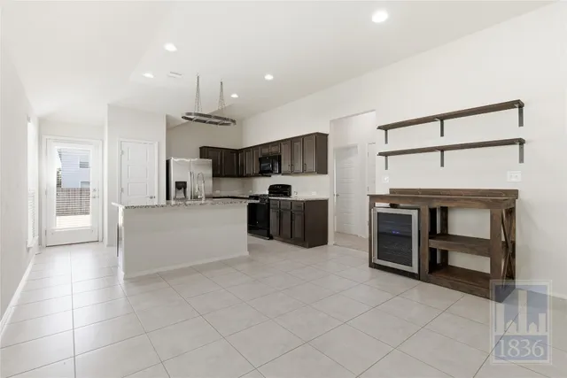 a large white kitchen with cabinets and stainless steel appliances