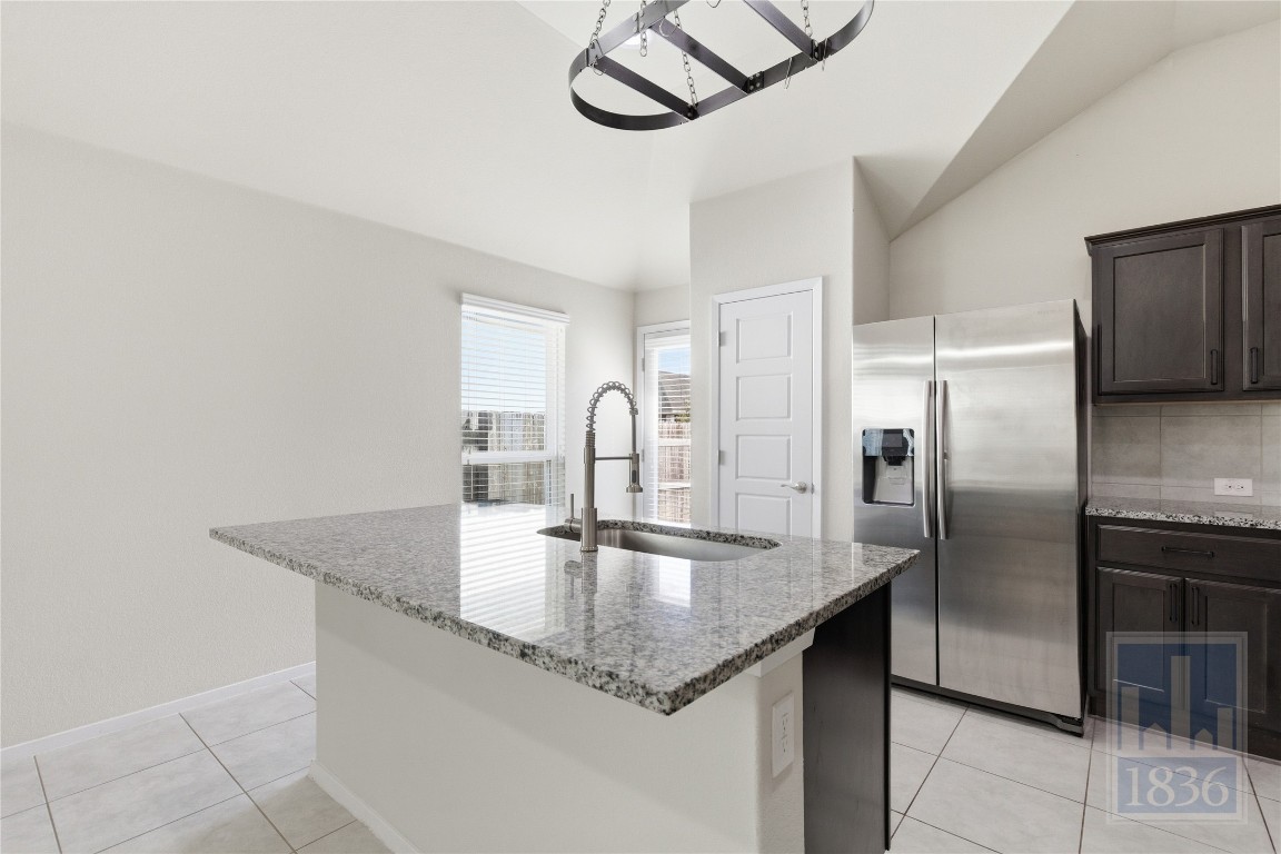 7615 Europa Avenue, Unit 139 Round Rock, TX 78665 - Photo 18 of 40 a kitchen with stainless steel appliances granite countertop a sink and a refrigerator