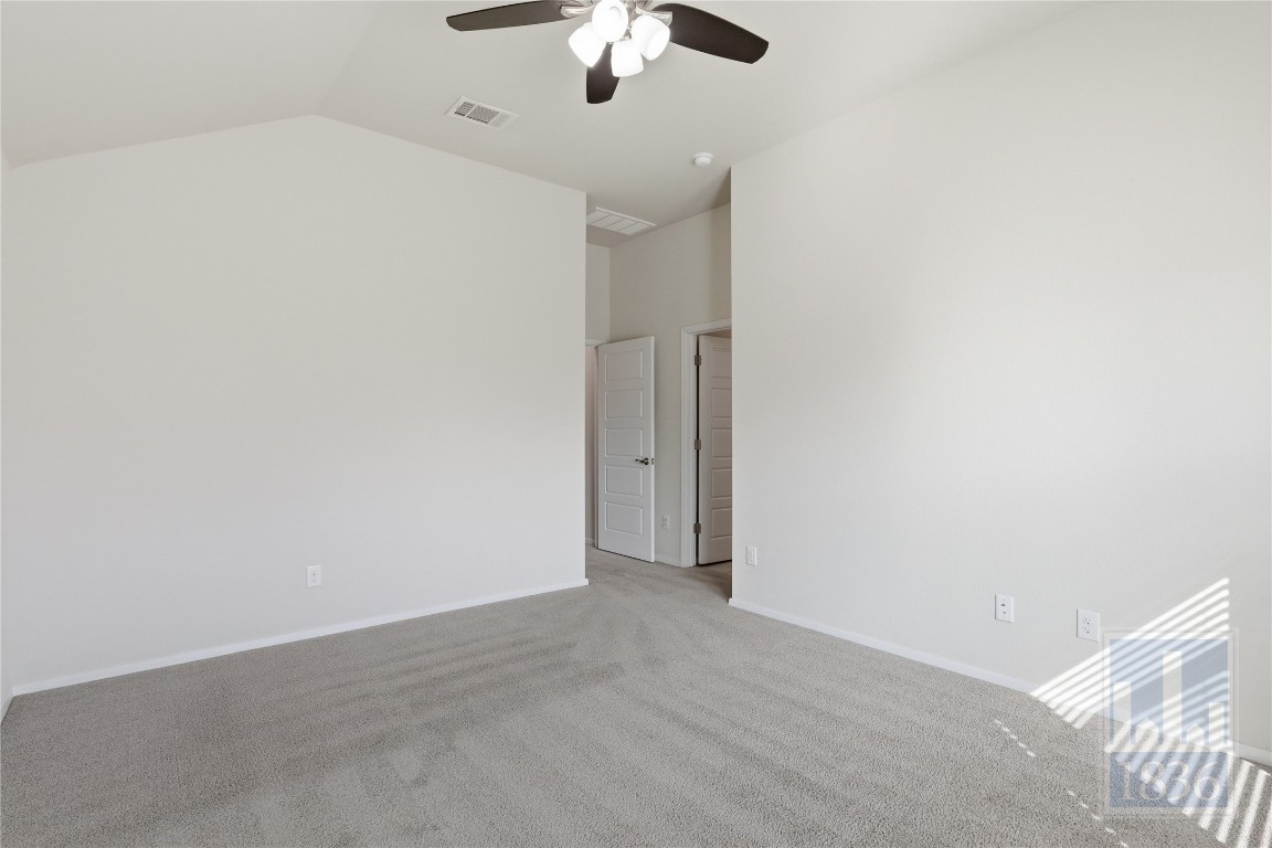 7615 Europa Avenue, Unit 139 Round Rock, TX 78665 - Photo 21 of 40 an empty room with a chandelier fan