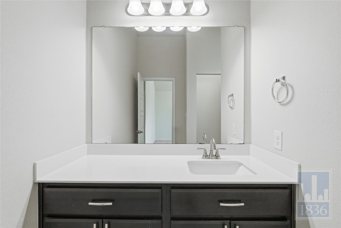 7615 Europa Avenue, Unit 139 Round Rock, TX 78665 - Photo 24 of 40 a bathroom with a sink and a mirror