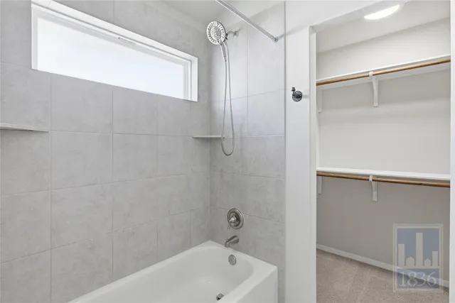 a bathroom with a tub and shower