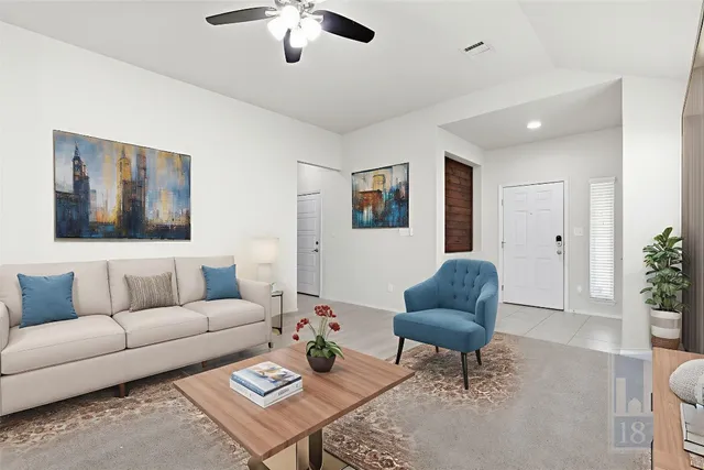 a living room with furniture and a potted plant