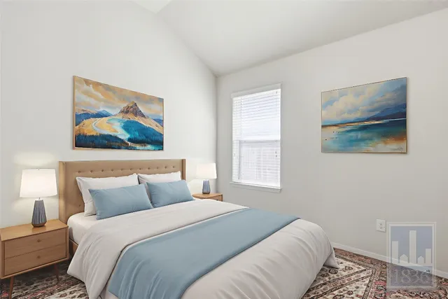 a bedroom with a bed and a painting on the wall