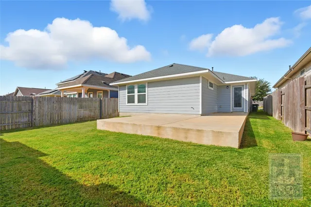 a view of a backyard with a garden and deck