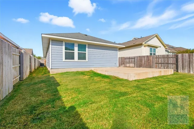 a view of a house with a backyard and porch