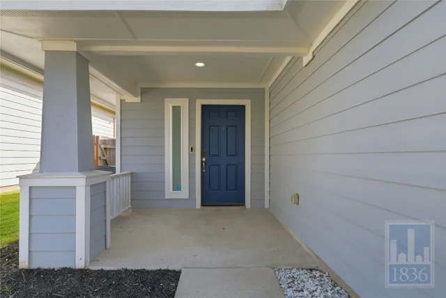 a view of an empty room with window and cabinet