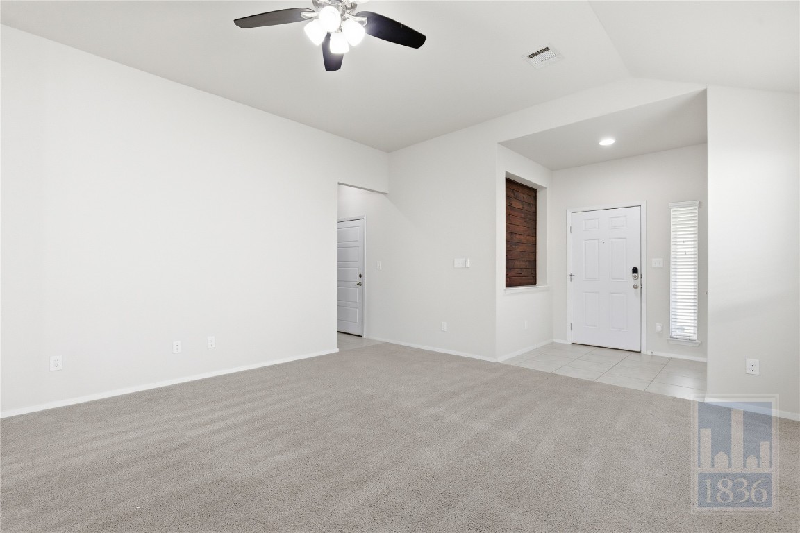7615 Europa Avenue, Unit 139 Round Rock, TX 78665 - Photo 4 of 40 an empty room with chandelier fan and windows