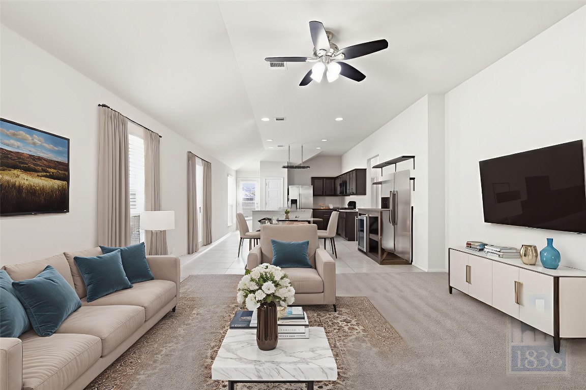 7615 Europa Avenue, Unit 139 Round Rock, TX 78665 - Photo 5 of 40 a living room with furniture and a flat screen tv