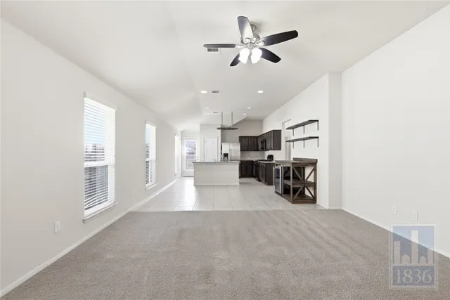 a view of a livingroom with furniture and a ceiling fan