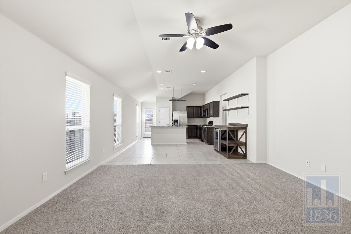 7615 Europa Avenue, Unit 139 Round Rock, TX 78665 - Photo 6 of 40 a view of a livingroom with furniture and a ceiling fan