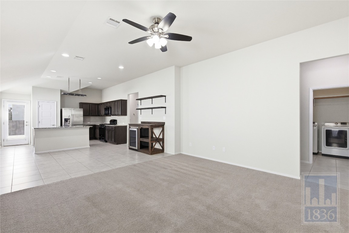 7615 Europa Avenue, Unit 139 Round Rock, TX 78665 - Photo 7 of 40 a view of a livingroom with furniture and kitchen