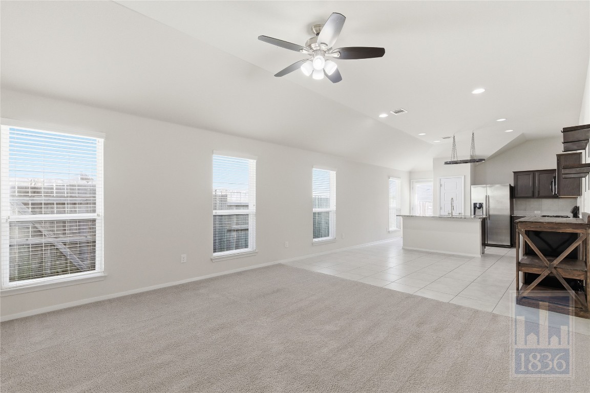 7615 Europa Avenue, Unit 139 Round Rock, TX 78665 - Photo 9 of 40 a view of a livingroom with furniture ceiling fan and window