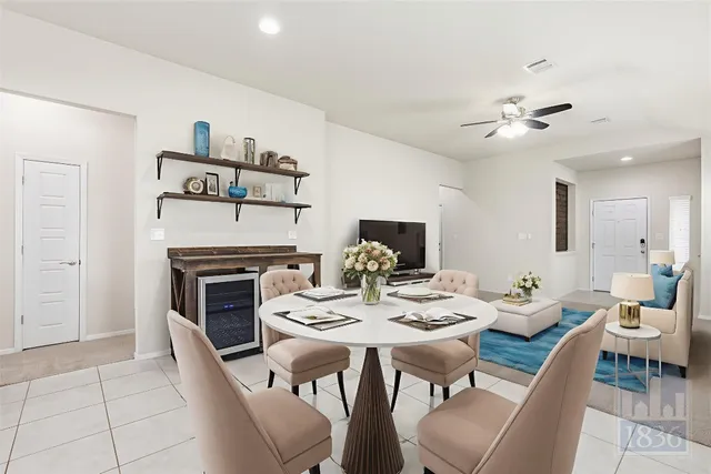 a view of a dining room with furniture a fireplace and wooden floor