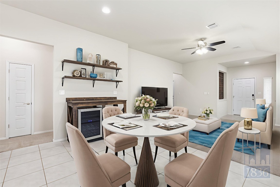 7615 Europa Avenue, Unit 139 Round Rock, TX 78665 - Photo 10 of 40 a view of a dining room with furniture a fireplace and wooden floor