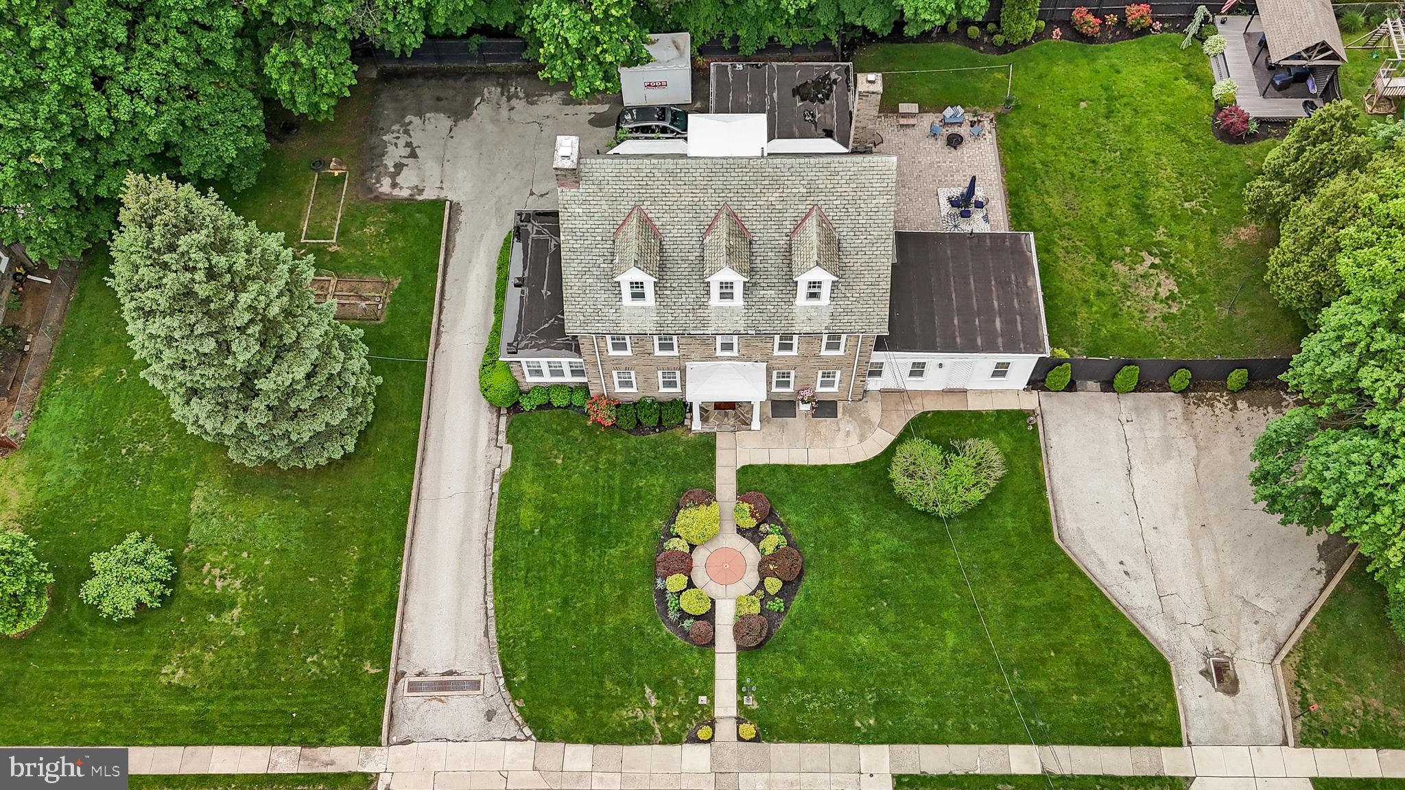 2515 Garrett Road Drexel Hill, PA 19026 - Photo 2 of 61 a view of a fountain in front of big yard with plants and large trees