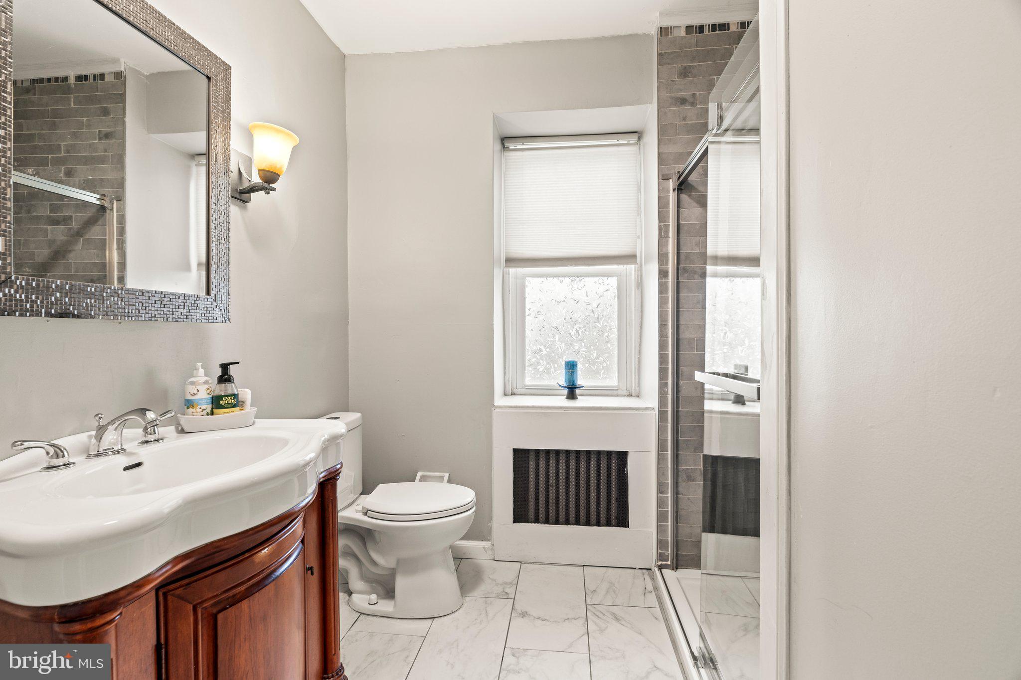 2515 Garrett Road Drexel Hill, PA 19026 - Photo 40 of 61 a bathroom with a sink toilet and mirror