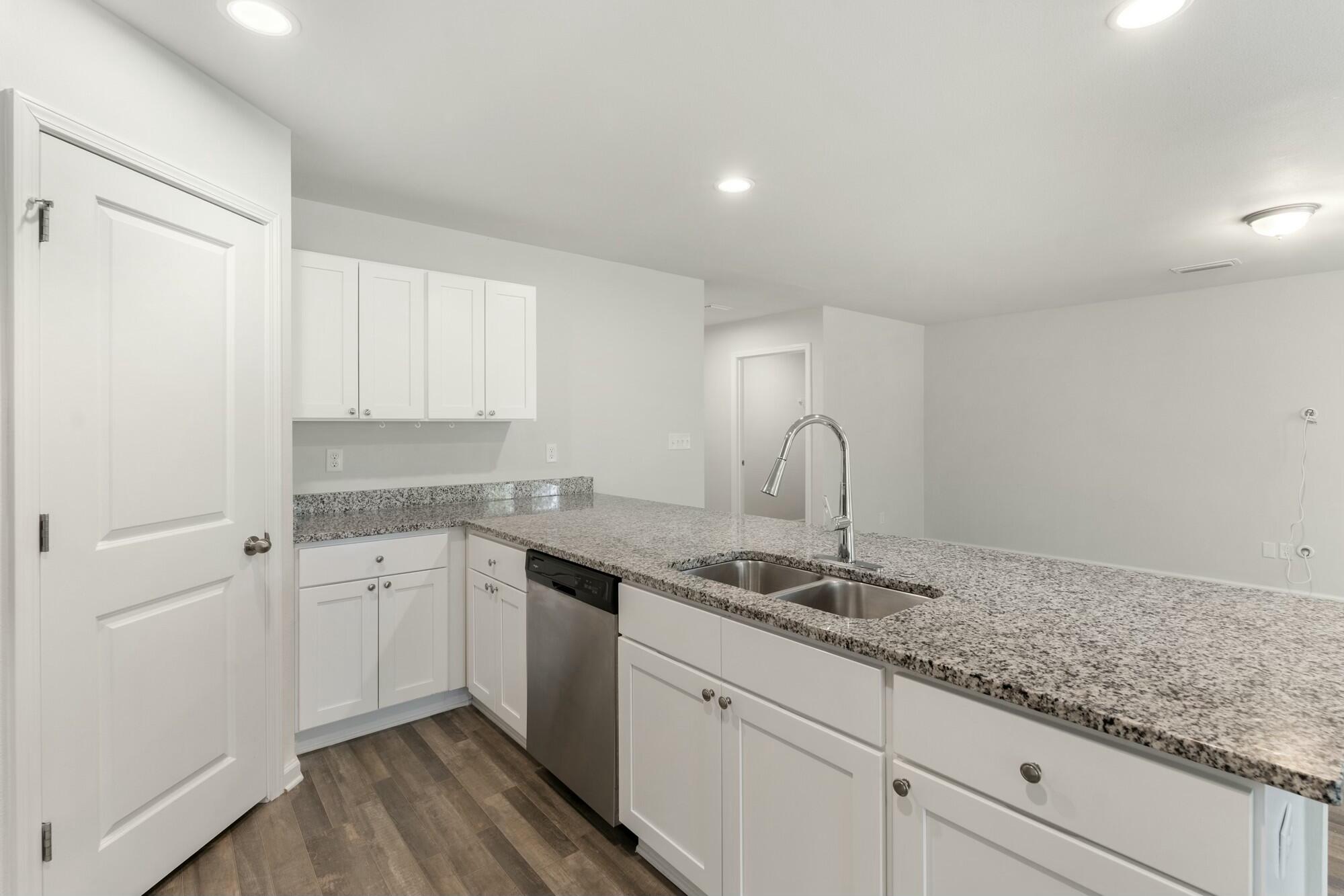 610 Riverwalk Circle Freeport, FL 32439 - Photo 16 of 50 a kitchen with granite countertop white cabinets and sink
