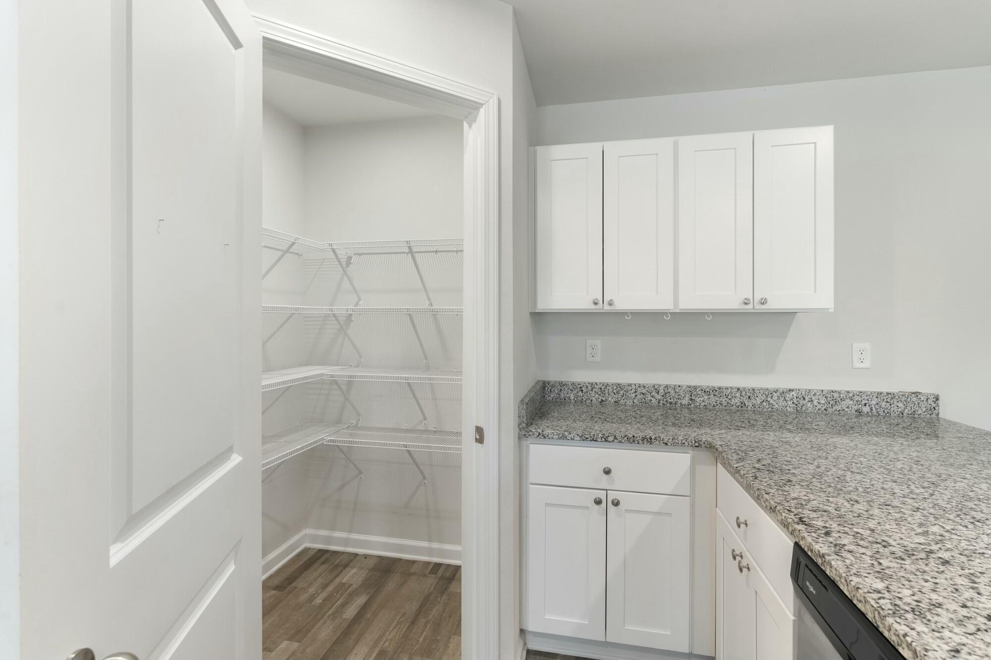 610 Riverwalk Circle Freeport, FL 32439 - Photo 18 of 50 a bathroom with granite countertop white cabinets and a granite counter tops