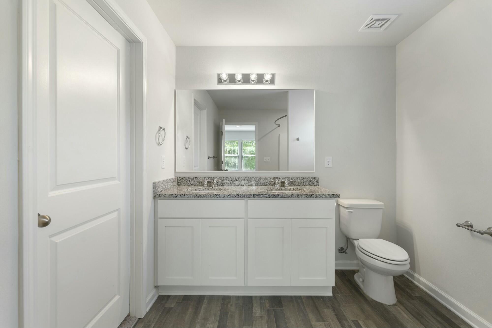 610 Riverwalk Circle Freeport, FL 32439 - Photo 25 of 50 a bathroom with a toilet sink and mirror