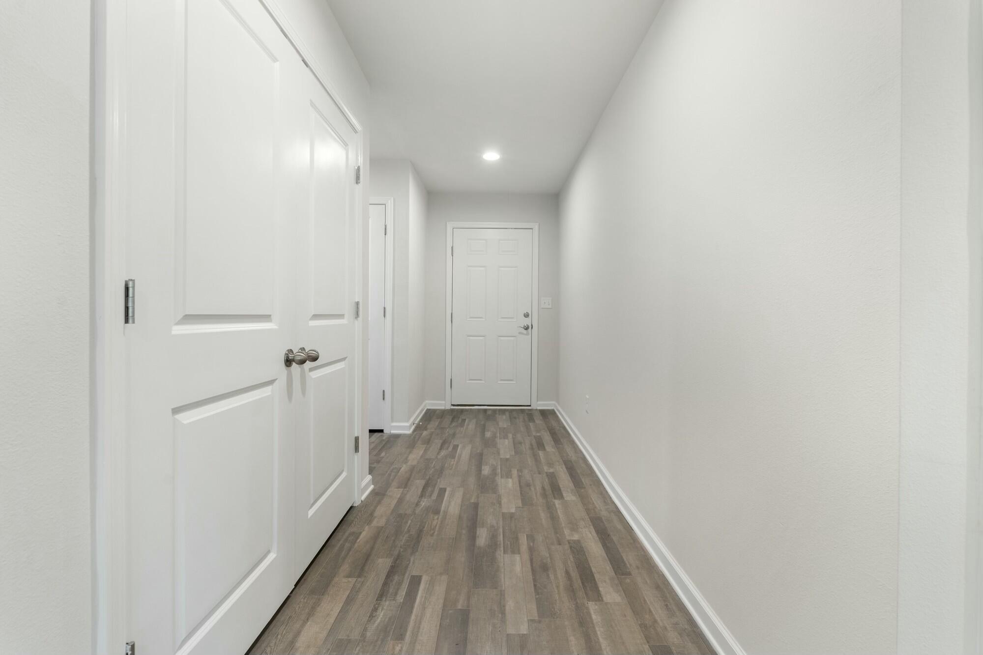 610 Riverwalk Circle Freeport, FL 32439 - Photo 27 of 50 a view of a hallway with wooden floor
